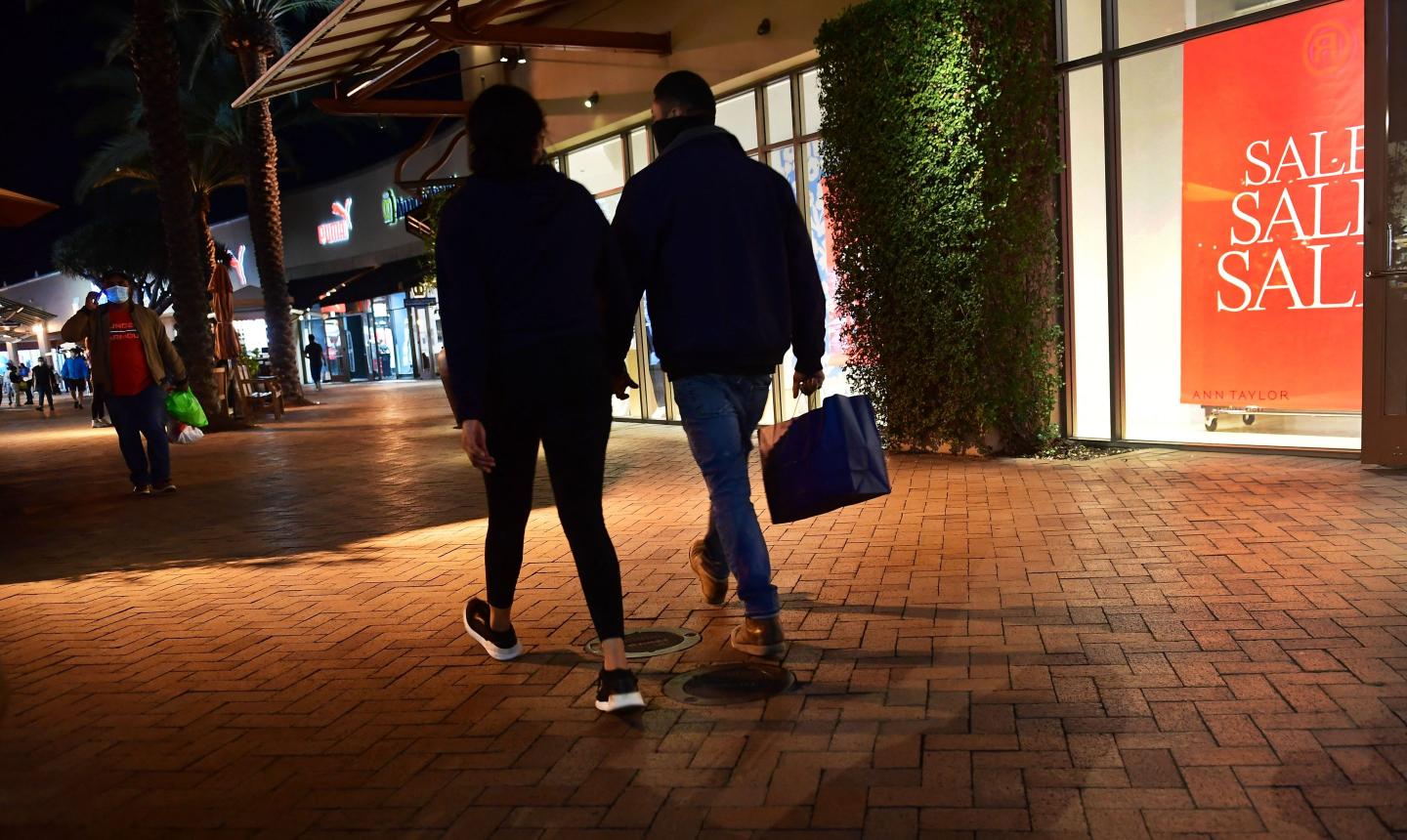 Two people walking with shopping bags