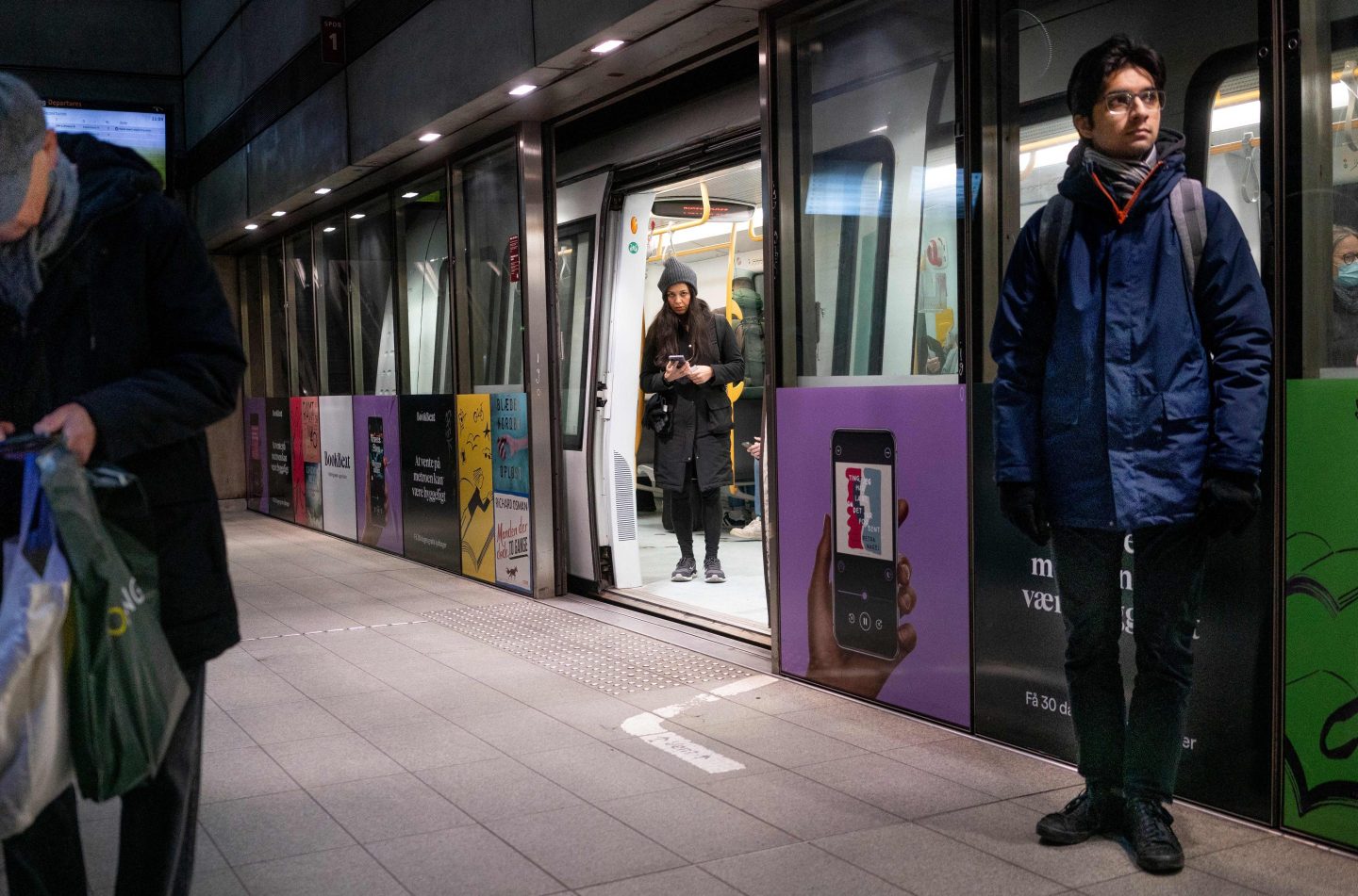 Commuters are seen at the Noerreport metrostation in Copenhagen on February 1, 2022.