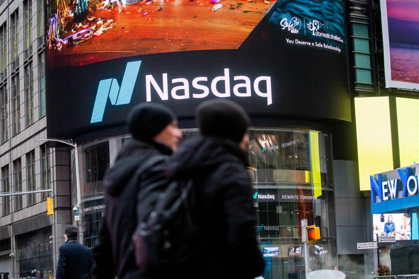 People walking past the Nasdaq MarketSite in New York