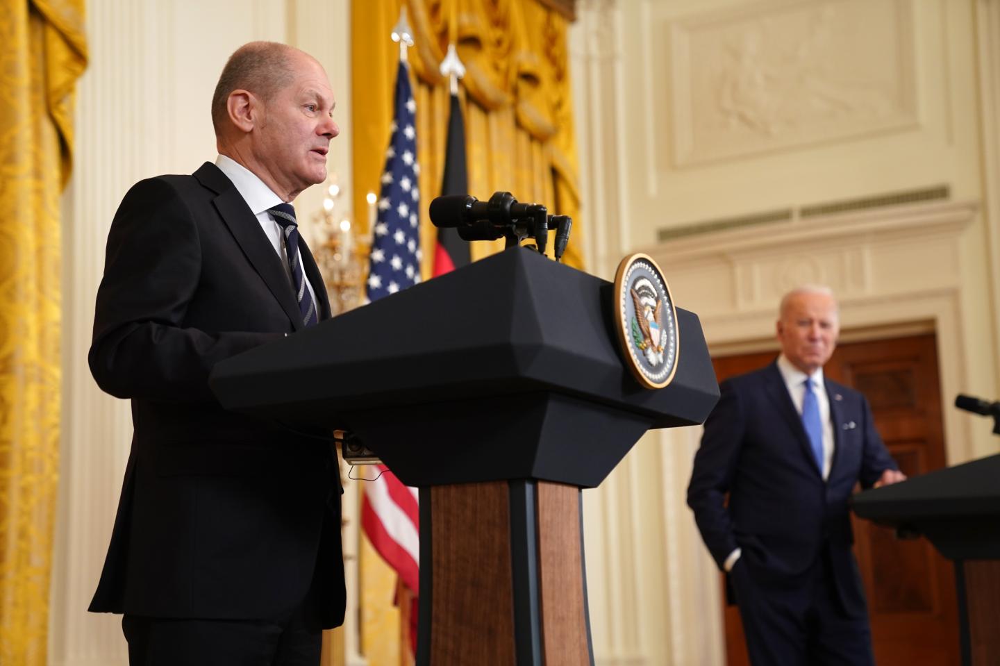 Olaf Scholz, Germany's chancellor, left, speaks during a news conference with U.S. President Joe Biden in the East Room of the White House in Washington, D.C., U.S., on Monday, Feb. 7 2022.