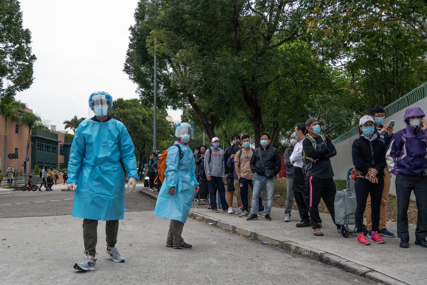 Residents wait in line at a Covid-19 testing facility in Discovery Bay on Lantau Island in Hong Kong, China, on Wednesday, Feb. 9, 2022.