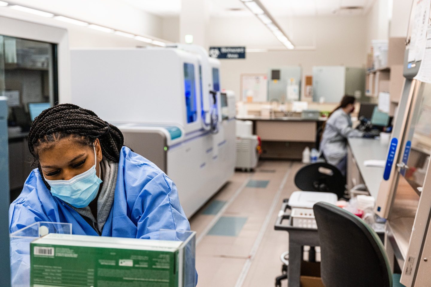 Medical technicians in a lab running a PCR test for COVID-19