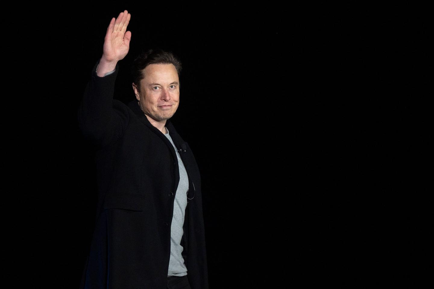 Elon Musk gestures during a press conference