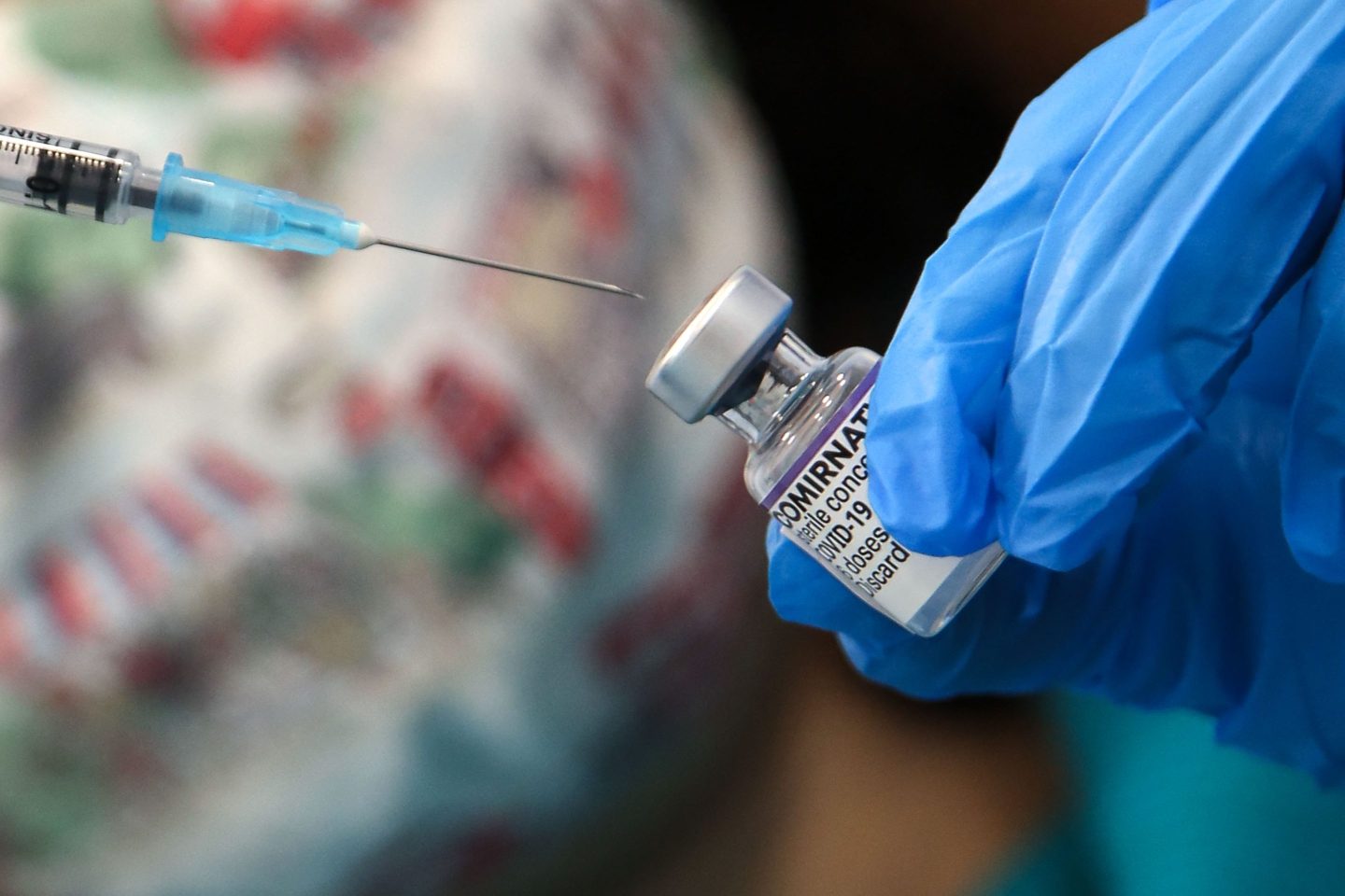 A vaccinator prepares to administer Pfizer/BioNTech COVID-19