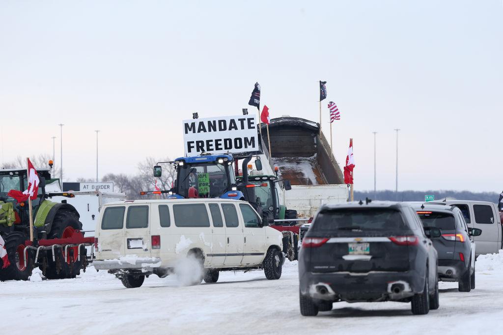 Trucks and tractors blockade the U.S.-Canada border crossing during a demonstration in Emerson, Manitoba, Canada, on Sunday, Feb. 13, 2022.