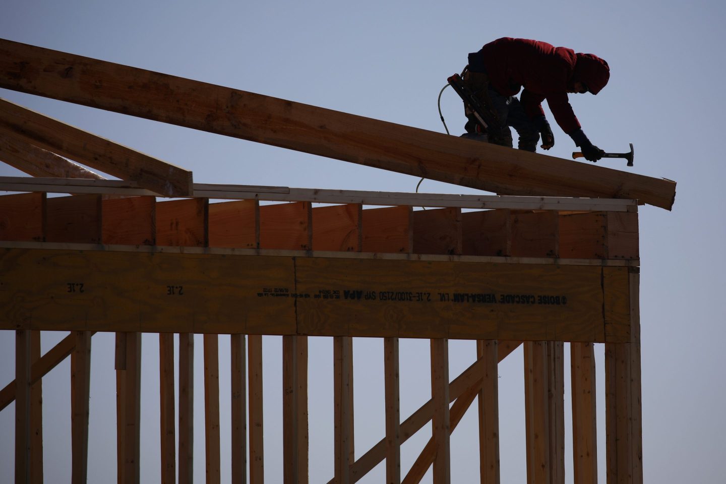 A contractor works on the framing of a house in Kentucky.