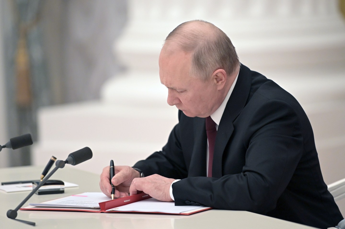 Russia's President Vladimir Putin signs decrees to recognize independence of the Donetsk and Lugansk People's Republics.