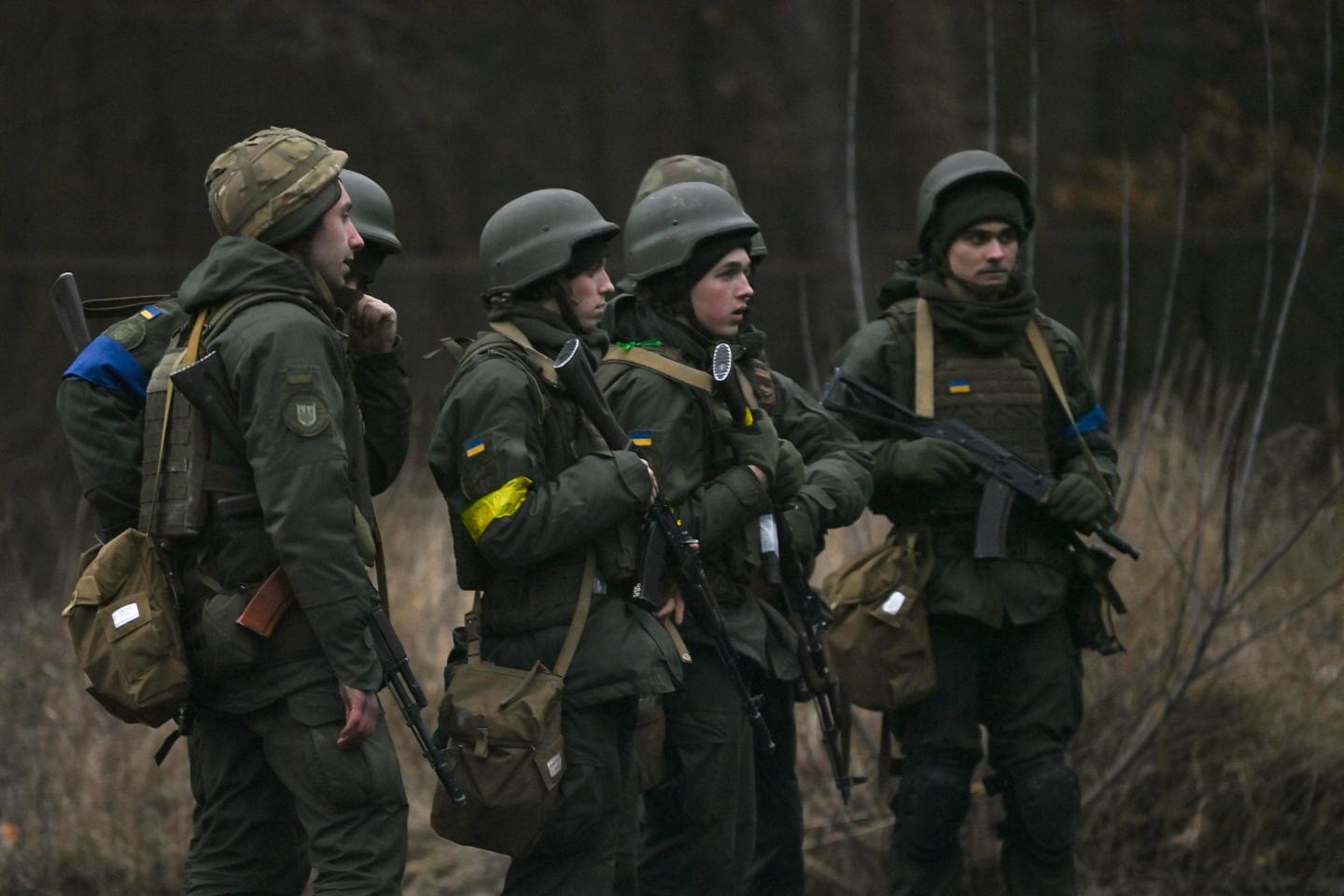 A photo of Ukrainian servicemen standing at a location north of Kyiv, on February 24, 2022.