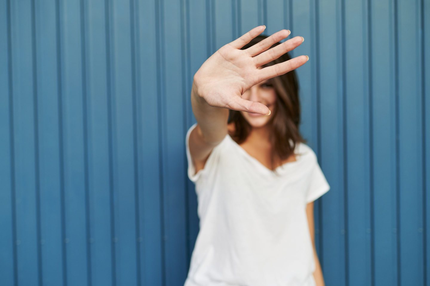 Portrait of a woman covering her face with her hand