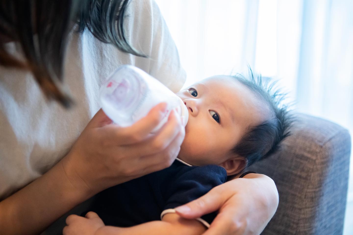 Infant drinking from bottle