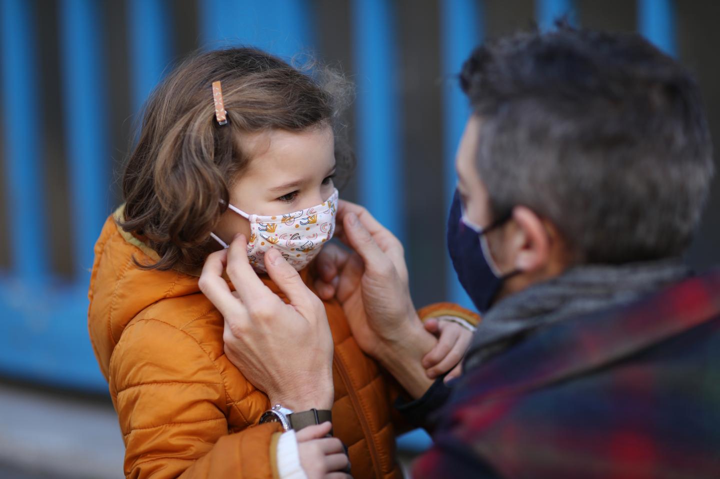 Child with protective face mask during COVID-19 pandemic.