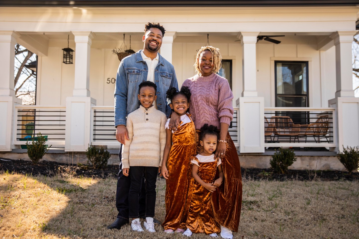 A family in front of their home
