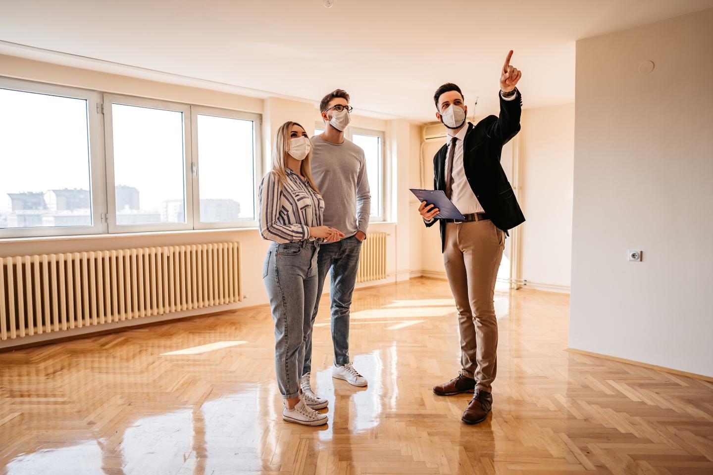 A real estate agent showing a couple a home for sale