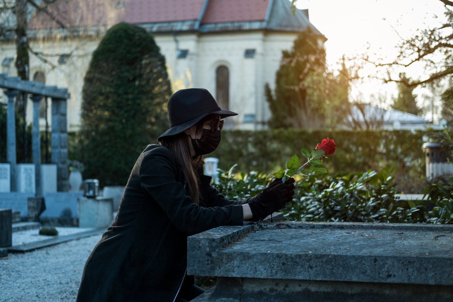 Woman wearing black dresses on cemetery.