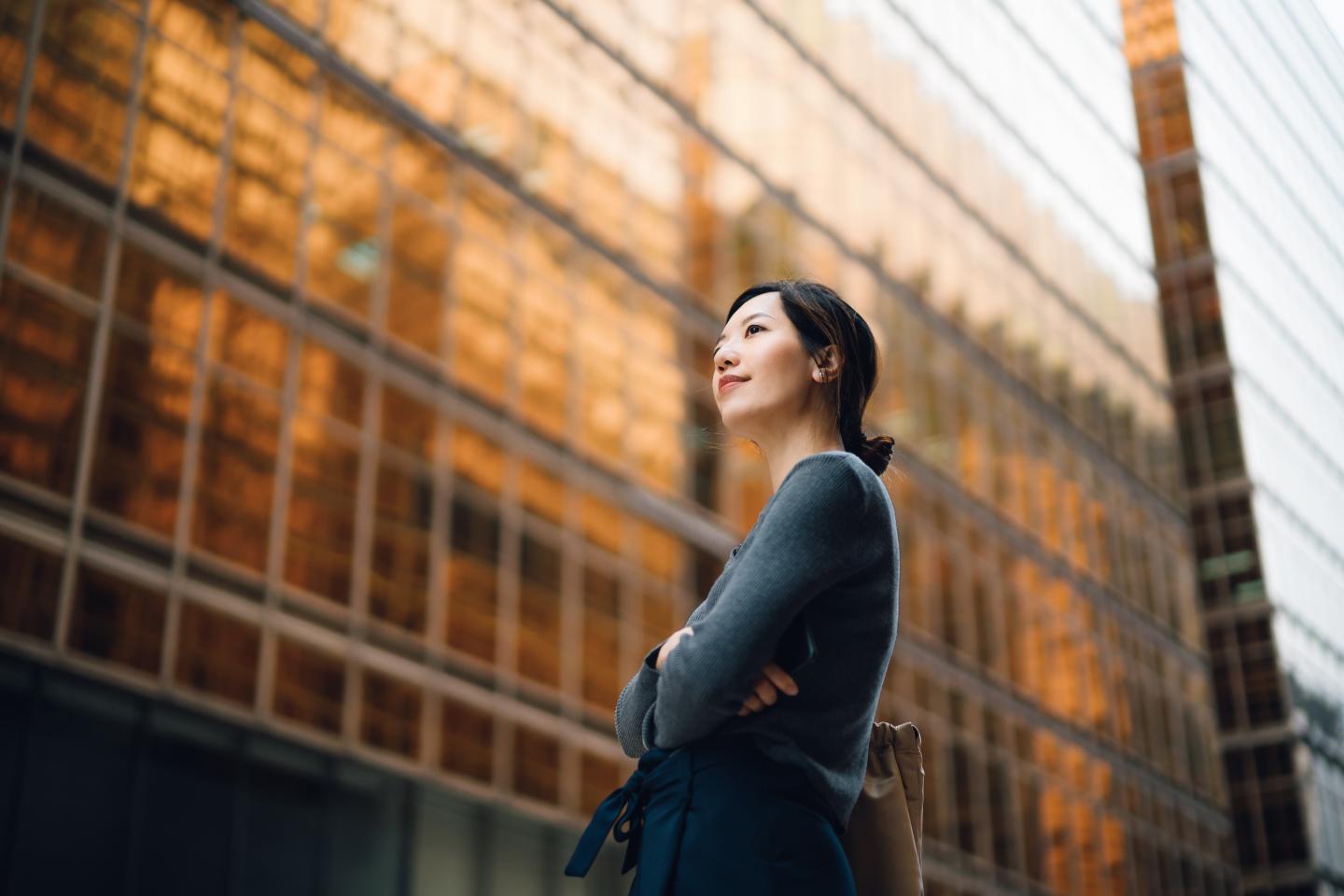Businesswoman looking at corporate skyscraper