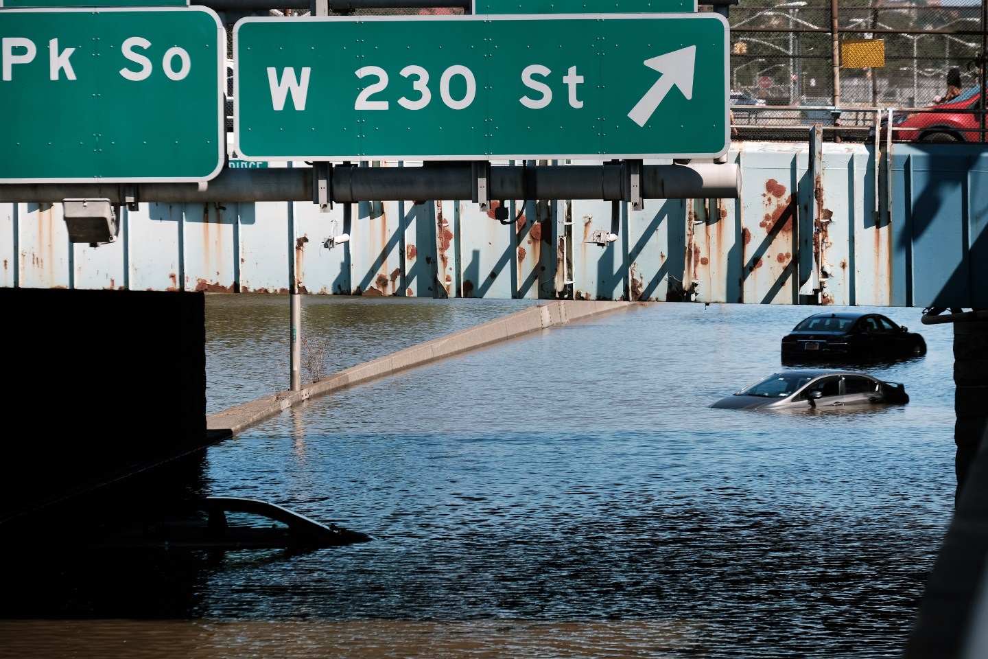 Cars are submerged by flood water under a bridge in New York