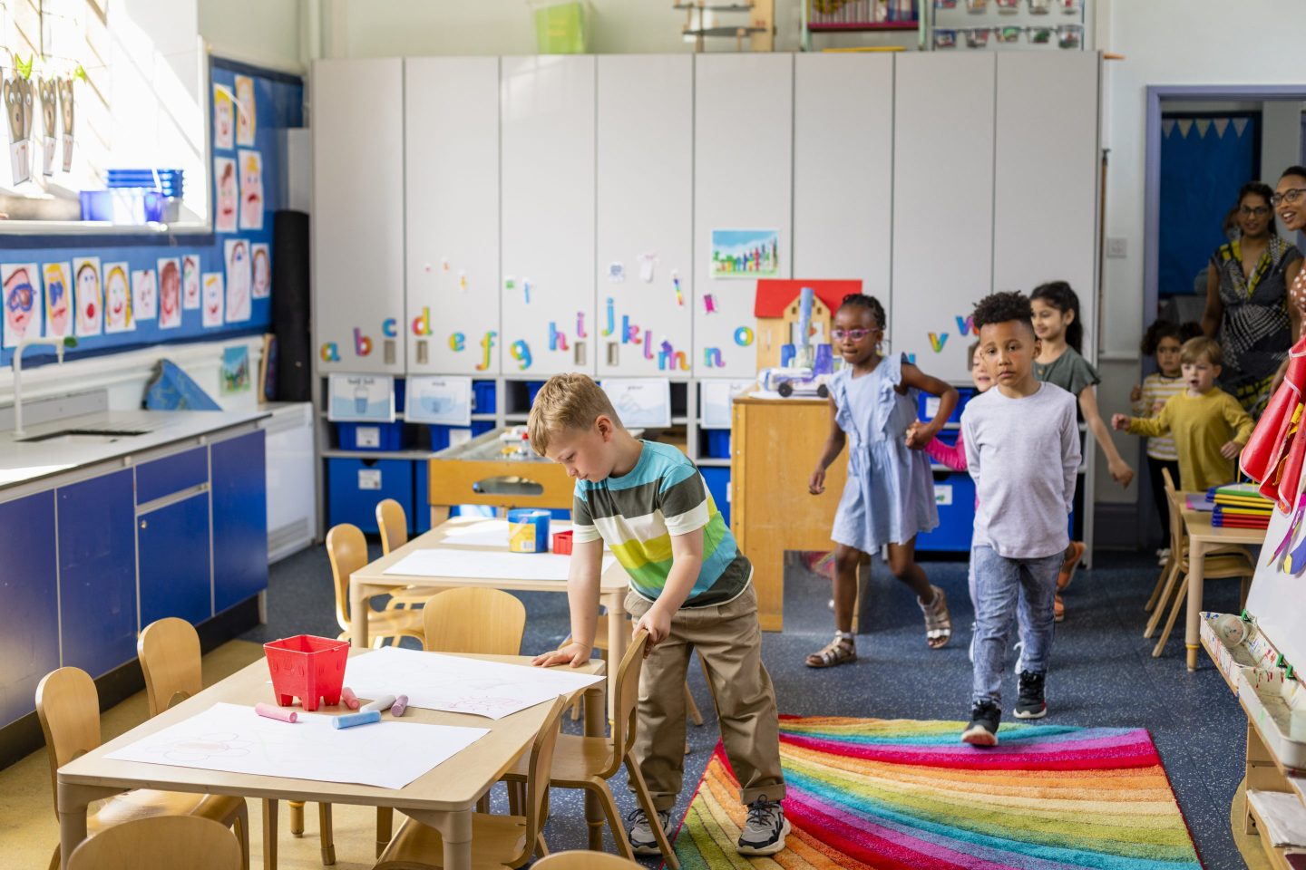 children walking into daycare center classroom