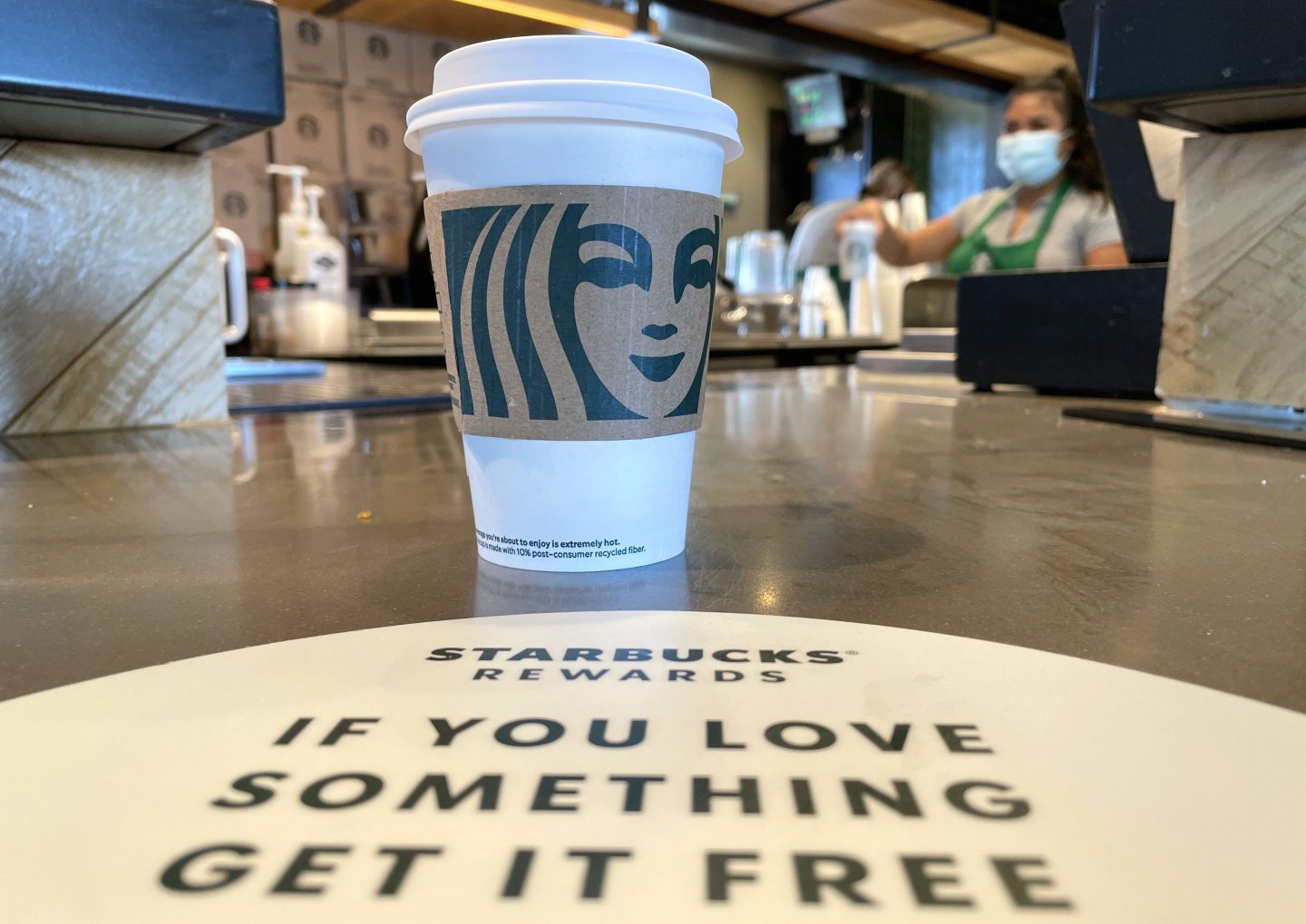 The Starbucks logo is displayed on a cup in a store in California