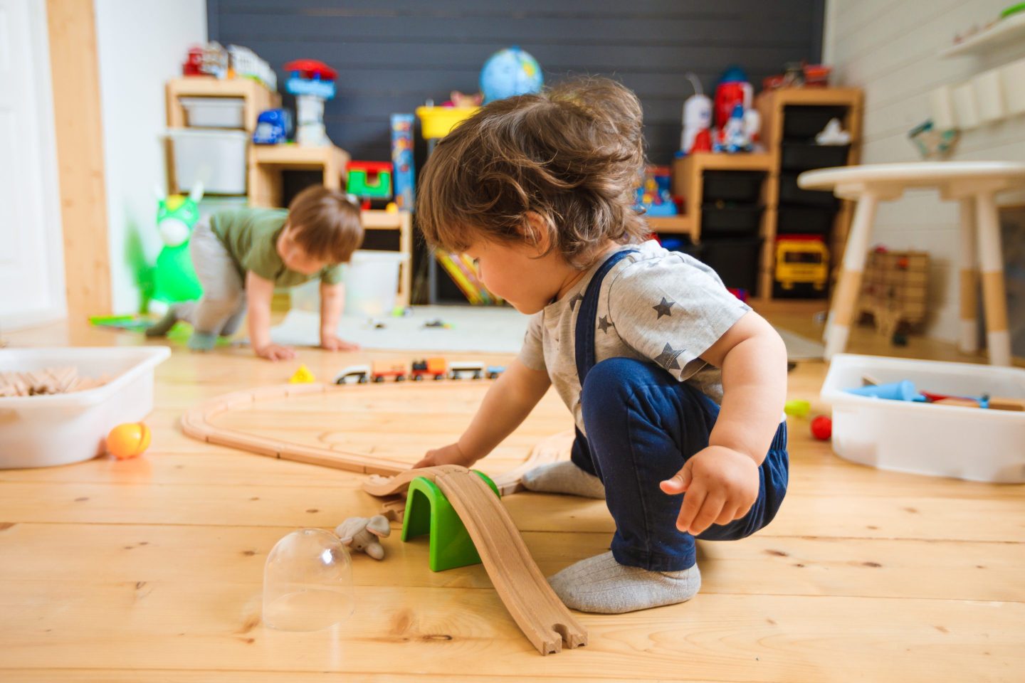 Young boy plays with toy at daycare