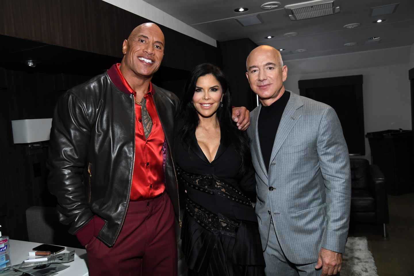 Left to right: Dwayne Johnson, Lauren Sanchez, and Jeff Bezos