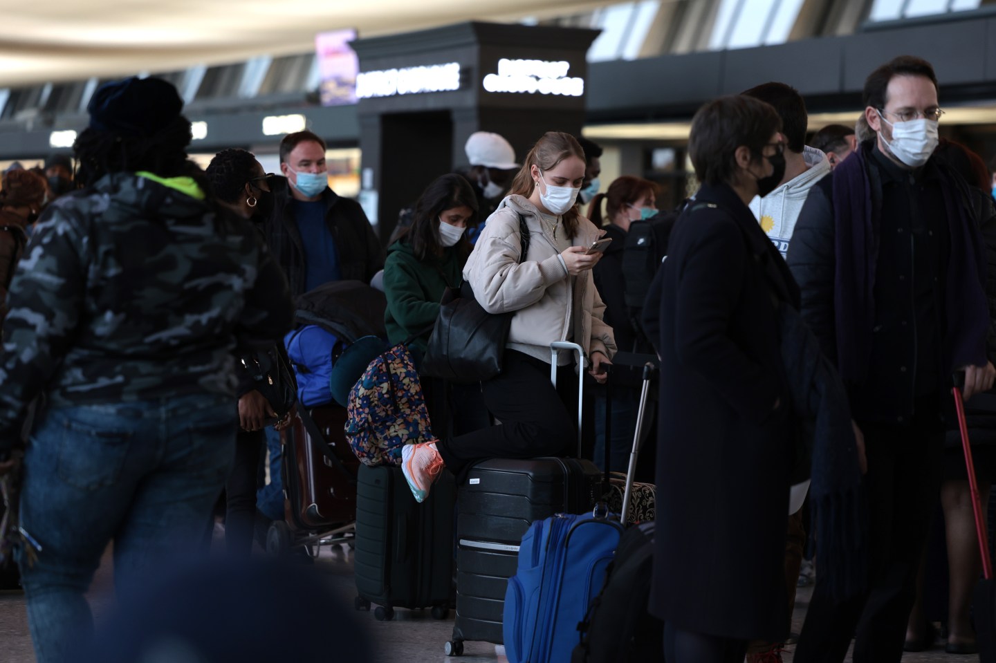 Passengers wait on line at airport