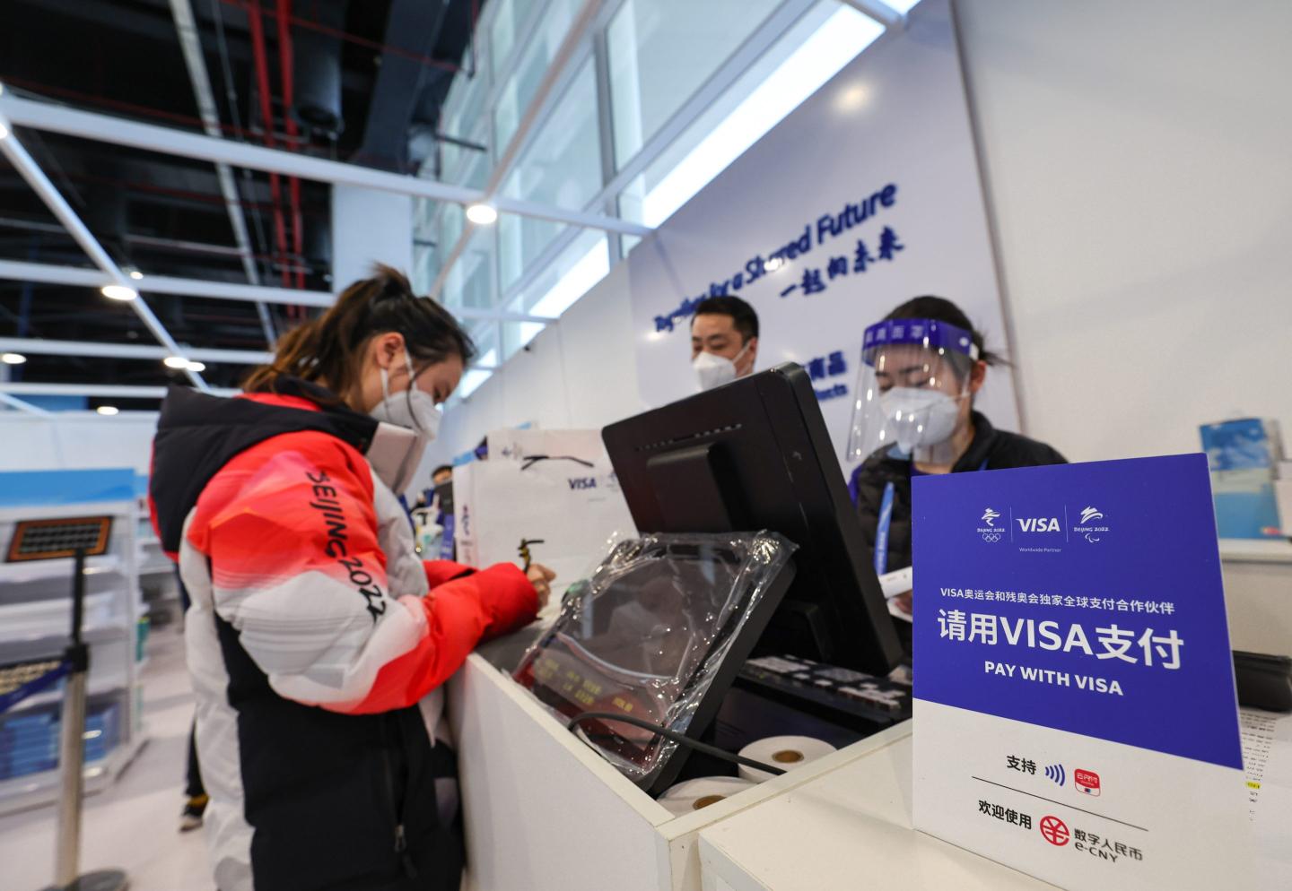 A person makes a purchase using China's digital currency, the e-CNY, in Beijing