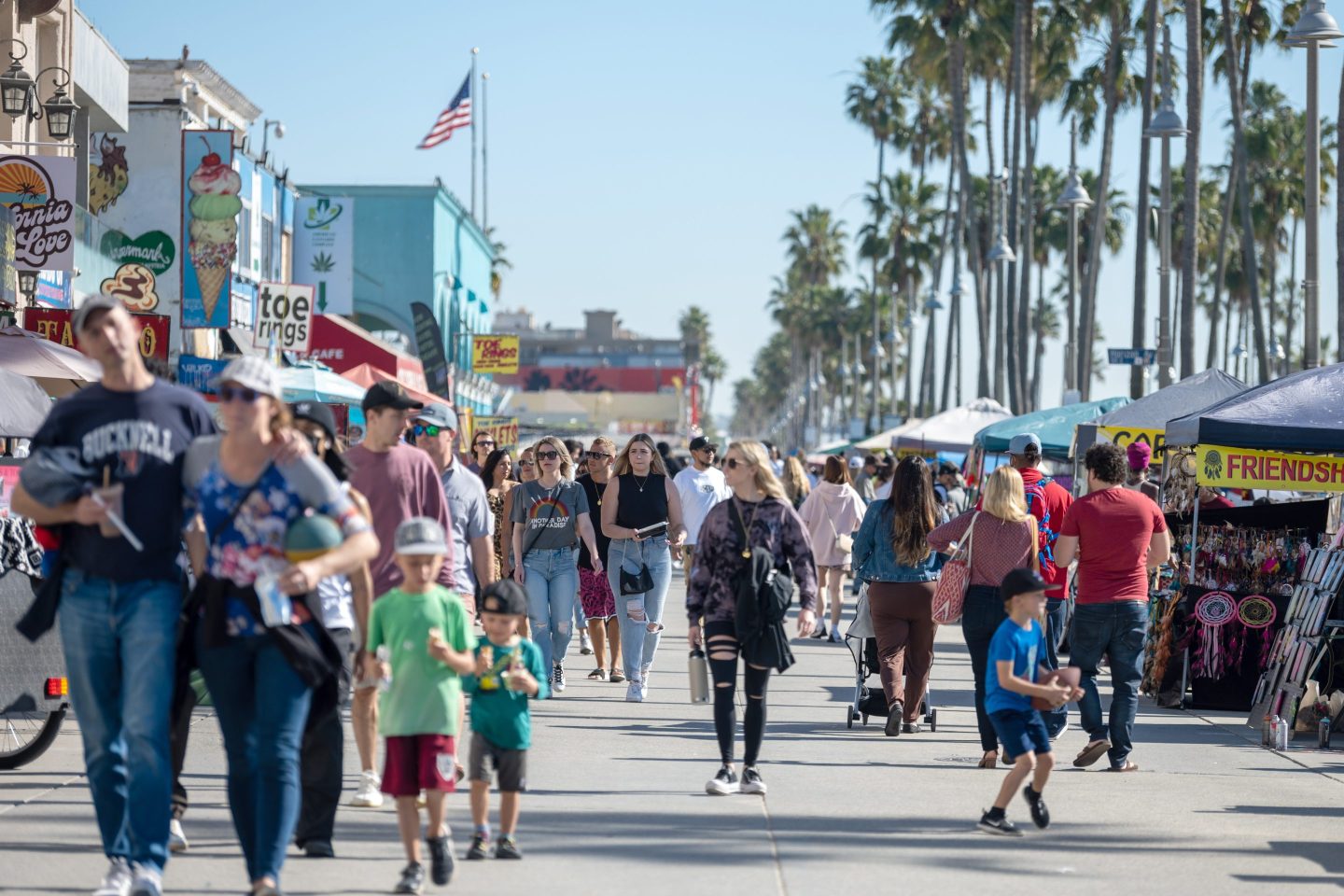 People walk along the Venice Beach boardwalk in Los Angeles