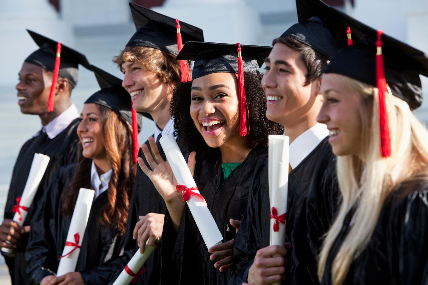 Friends graduating together, in cap and gown