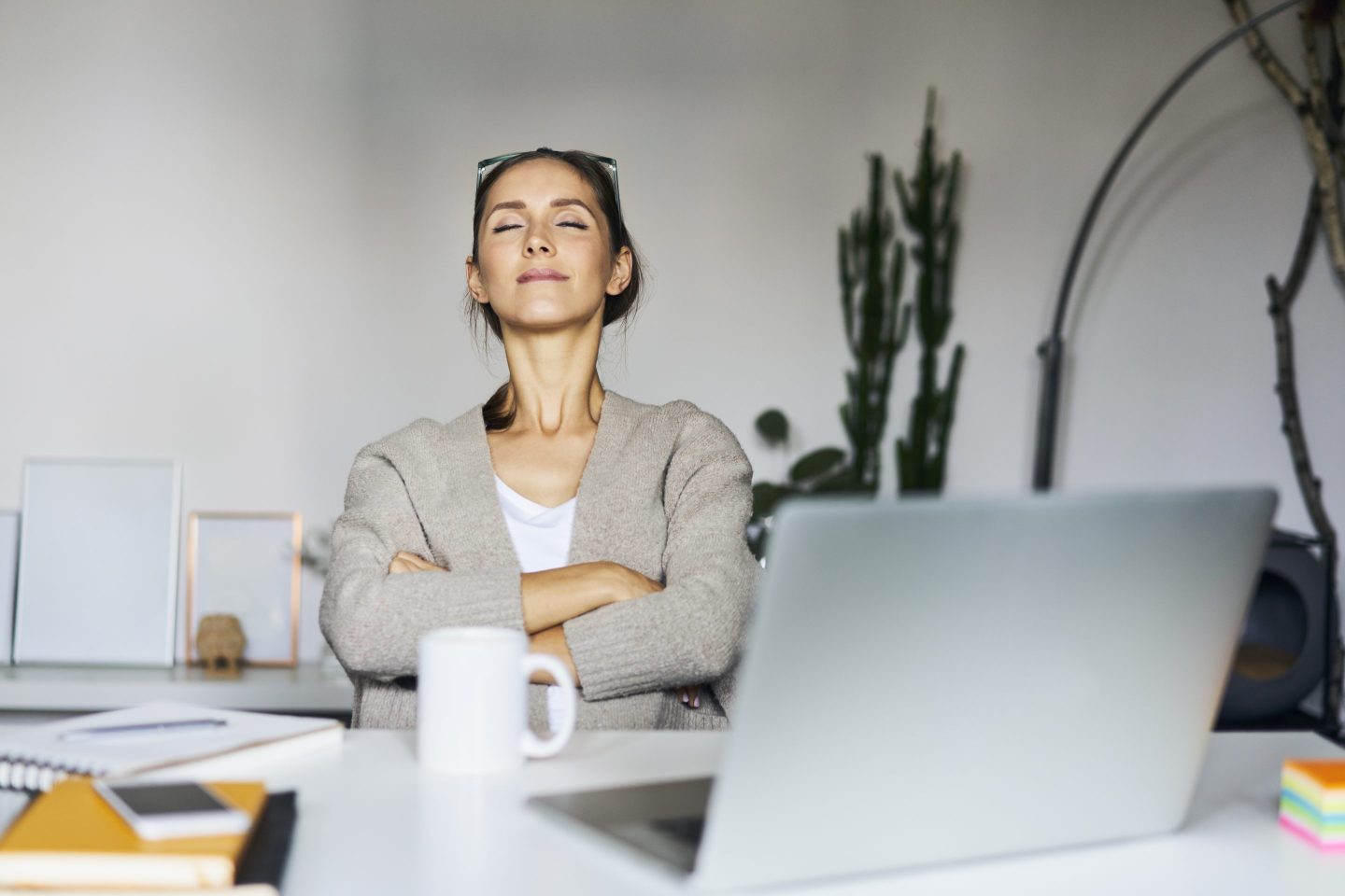 A young woman takes a break at her desk