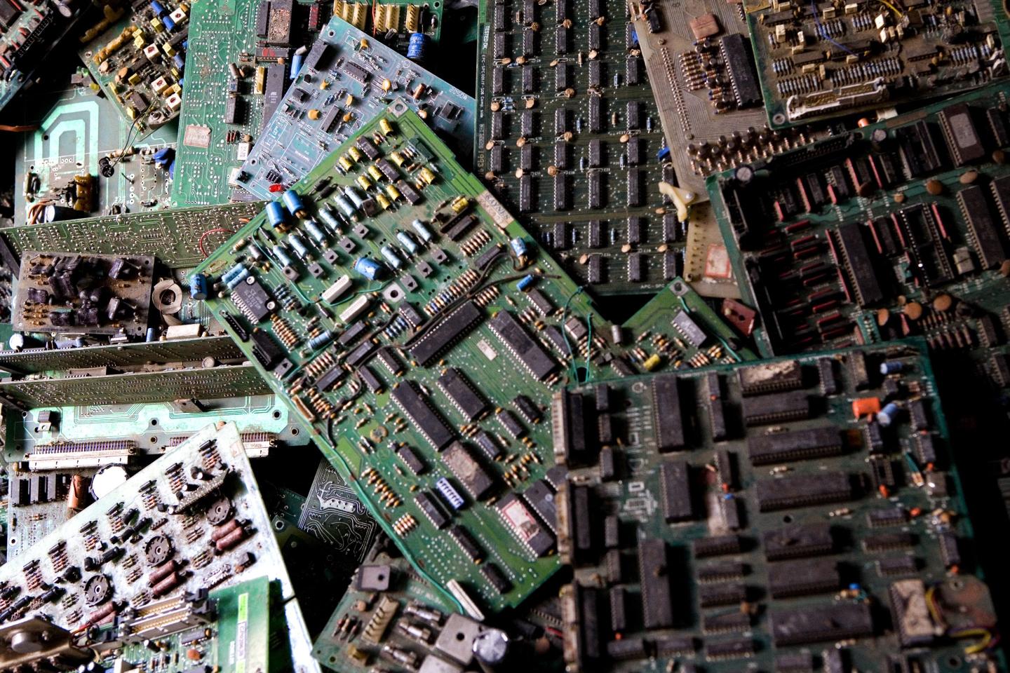 Discarded computer chip boards in a pile