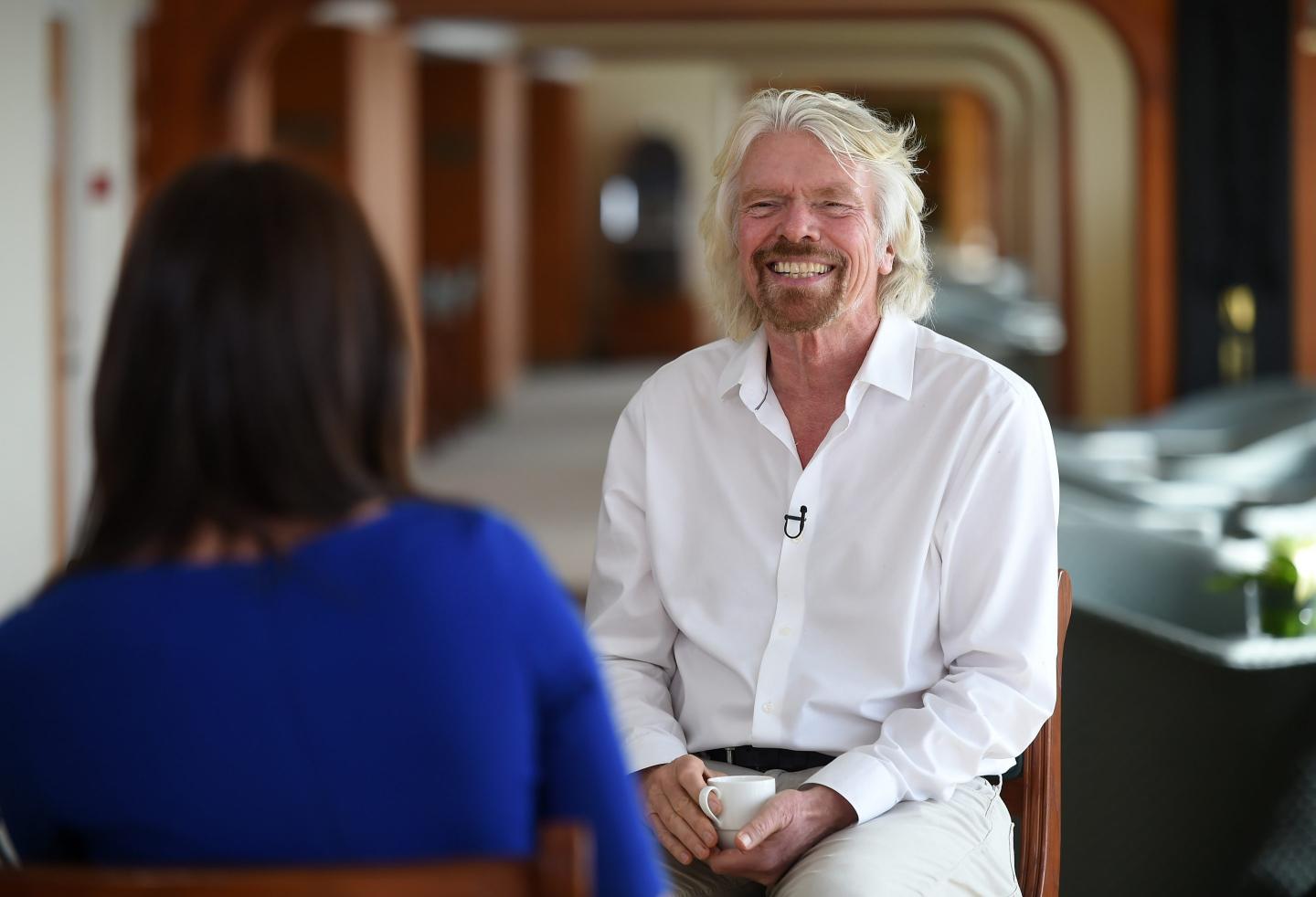 Richard Branson, wearing a white shirt, is interviewed in 2018