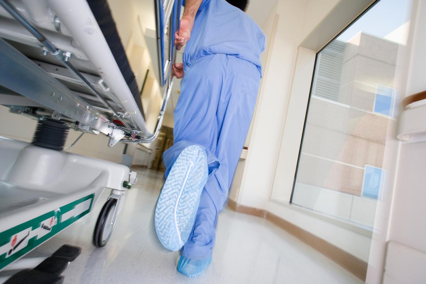 Surgeon pushing hospital gurney