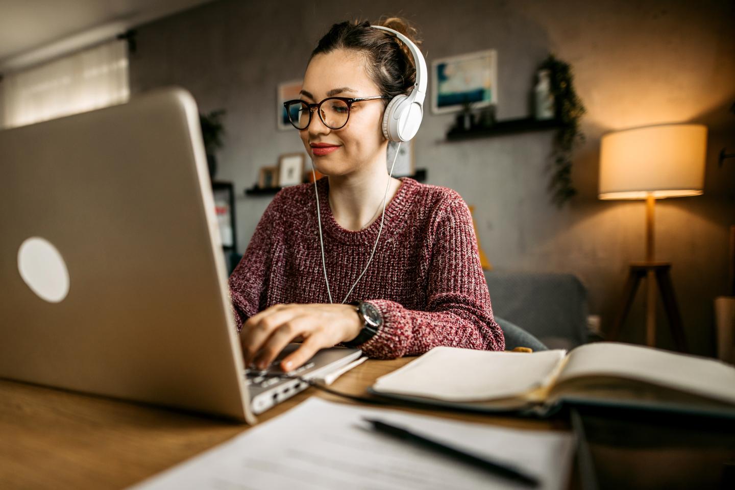 A woman studying at home on a computer