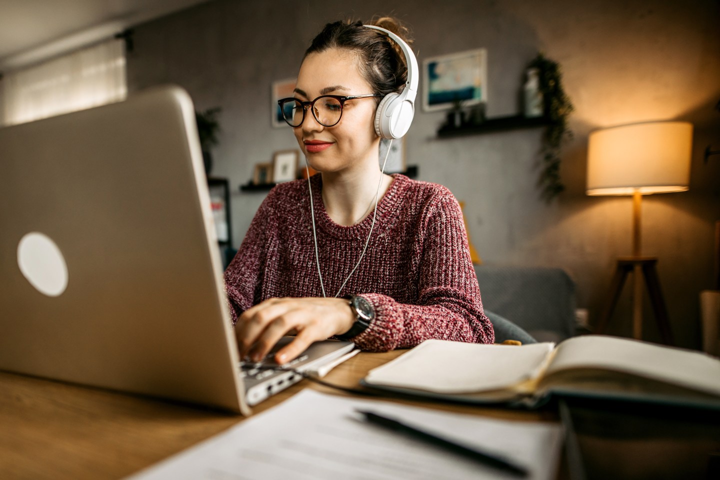 A woman studying at home on a computer