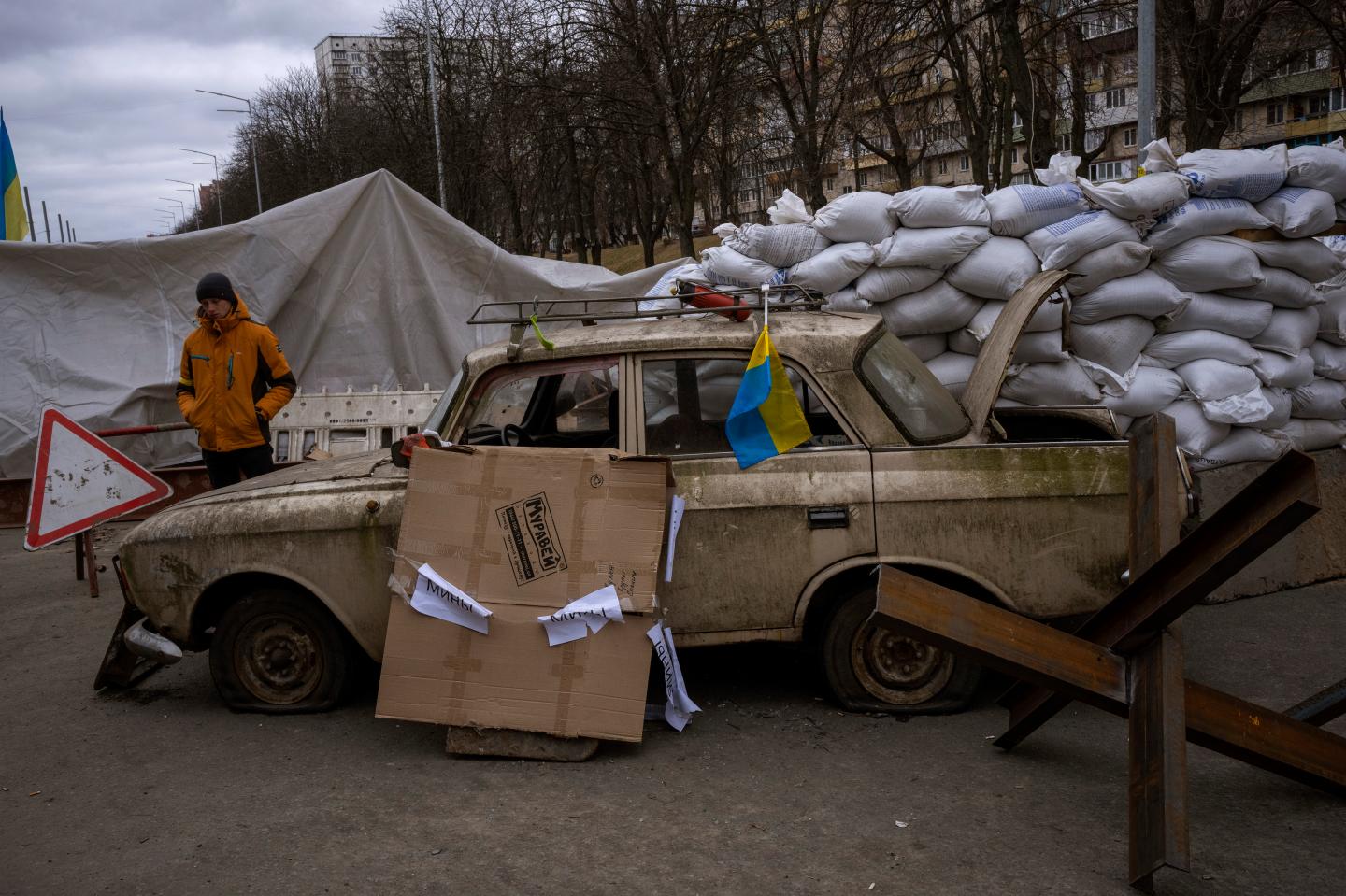 A militia man stands at a checkpoint set up on a road heading to the city of Kyiv, Ukraine, Saturday, March 5, 2022. Russian troops took control of the southern port city of Kherson this week. Although they have encircled Kharkiv, Mykolaiv, Chernihiv and Sumy, Ukrainian forces have managed to keep control of key cities in central and southeastern Ukraine, Ukrainian President Volodymyr Zelenskyy said Saturday.
