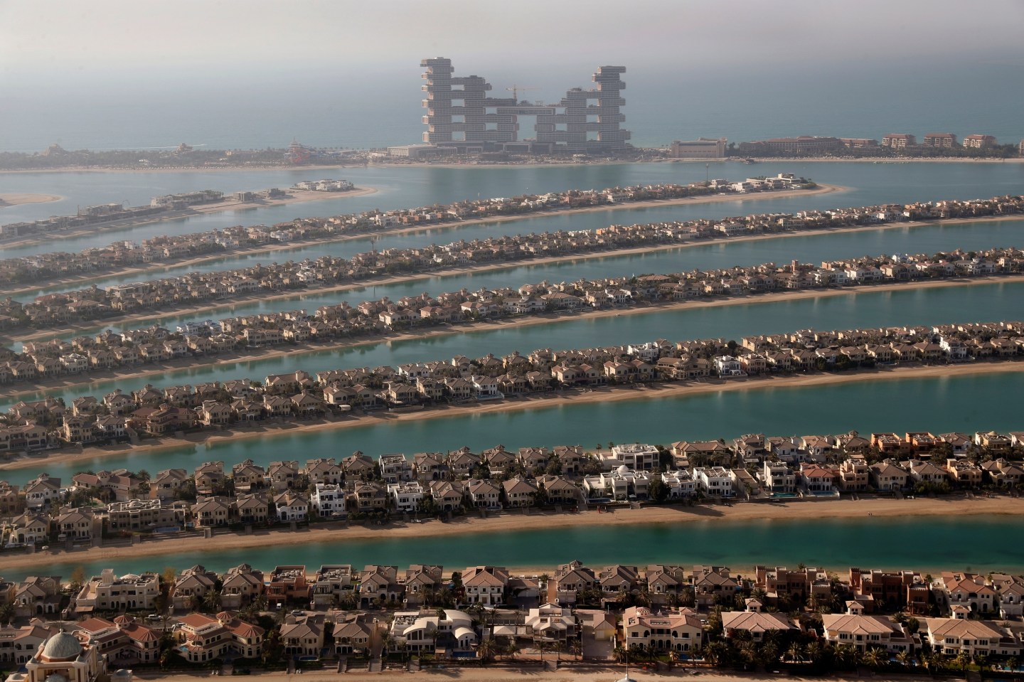 Villas on the fronds of the Jumeirah Palm Island are seen from the observation deck of The View at The Palm Jumeirah, in Dubai, United Arab Emirates, April 6, 2021. The Middle East is the most water-scarce region in the world, but participants at an upcoming climate summit in Dubai will be ensconced in a resort with one of the world’s largest water parks, complete with artificial lagoons, encounters with dolphins, and a mesmerizing aquarium with sharks, sting rays and schools of fish.