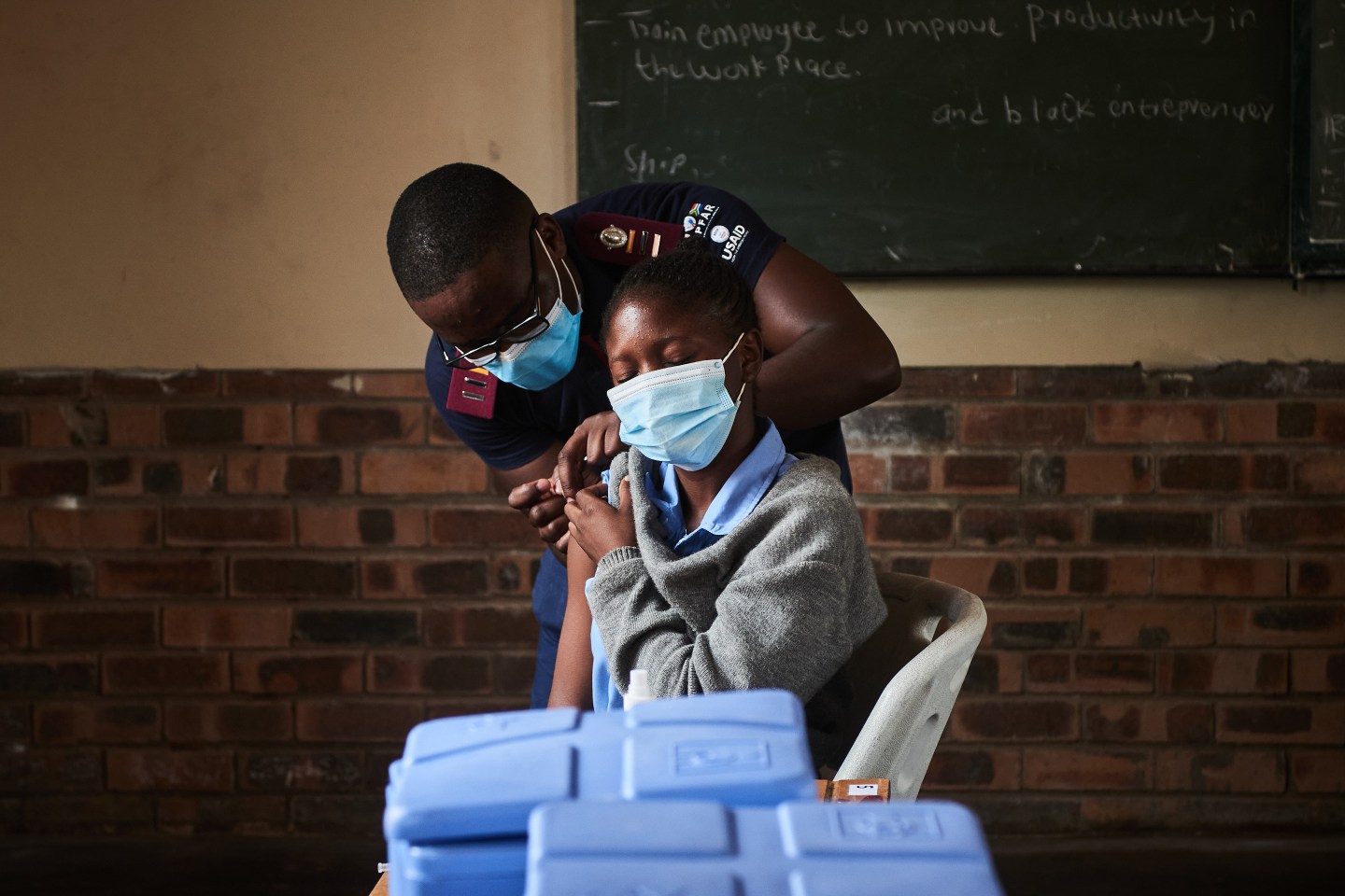 A health worker administers a Covid-19 vaccine to a student in South Africa.