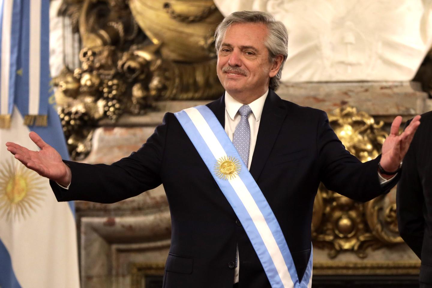 Argentinian President Alberto Fernandez with arms held wide as he receives foreign leaders in Buenos Aires, Argentina.