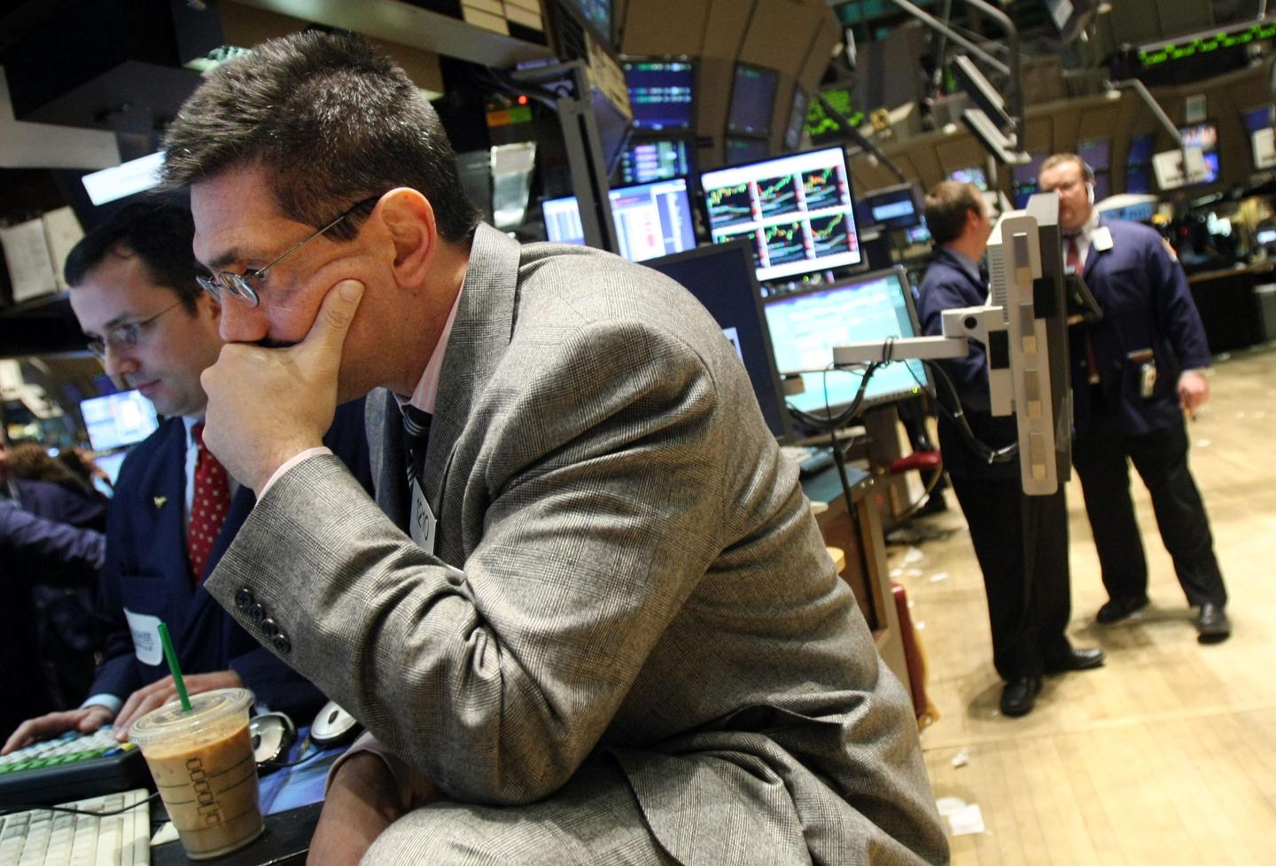 A trader on the New York Stock Exchange covers his mouth after a tough day during the Great Recession in 2007.