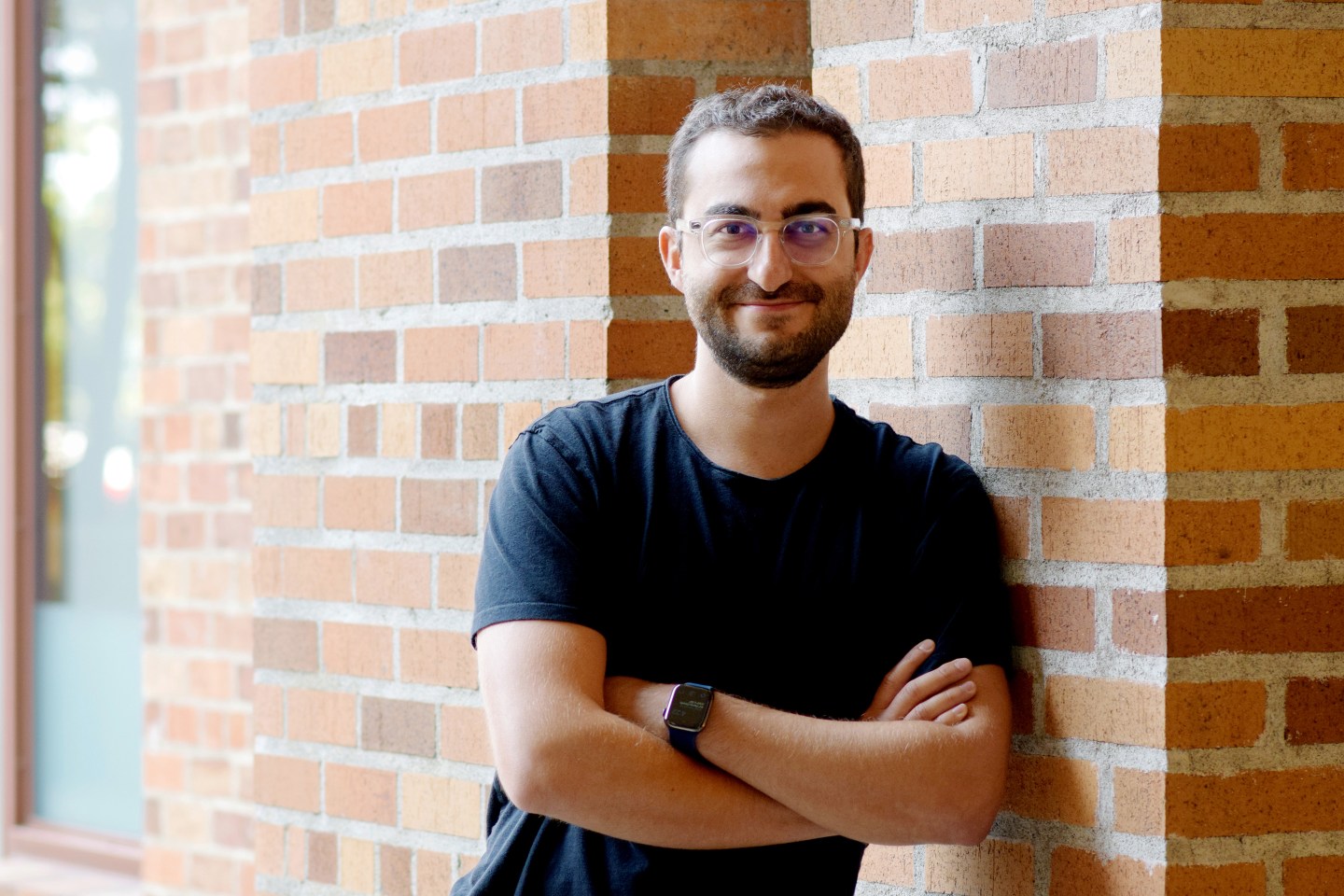 Gradient Ventures Partner Darian Shirazi poses for a picture in front of a brick building.