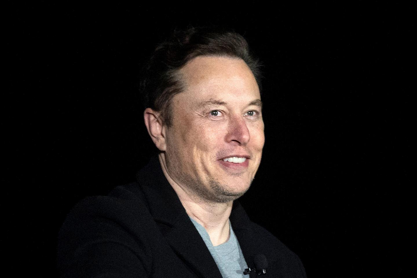 Elon Musk gestures as he speaks during a press conference at SpaceX's Starbase facility.