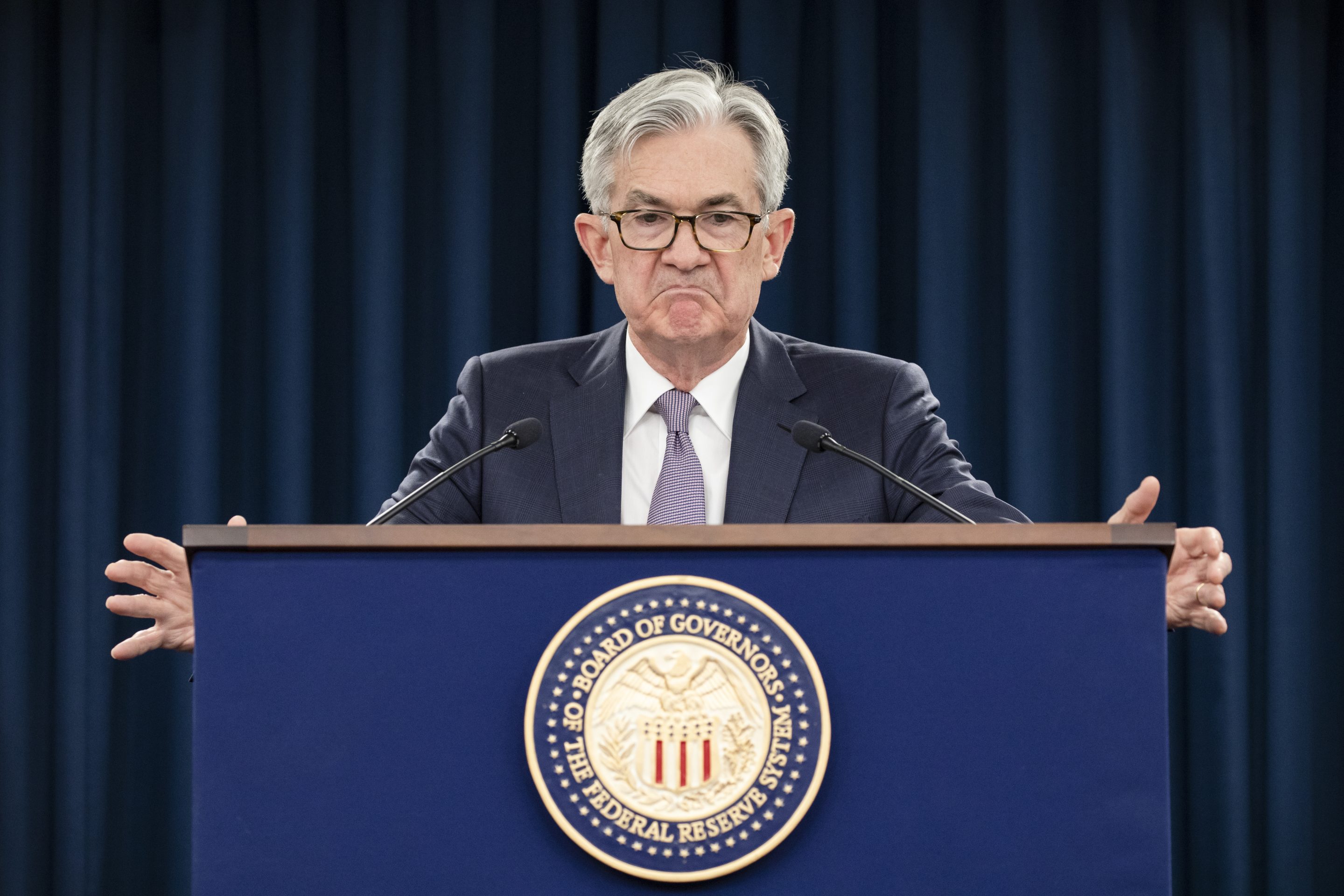 Fed chairman Jerome Powell with arms held wide.