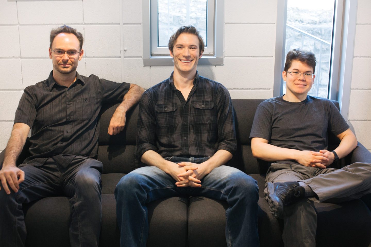 Picture of Modern Intelligence's three cofounders sitting on a sofa.