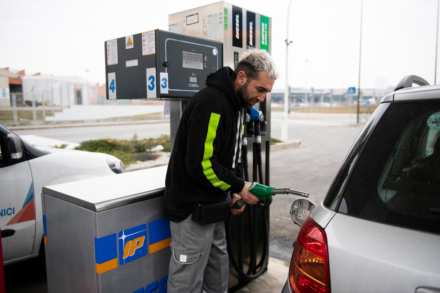 A man refuels a car in Turin, Italy