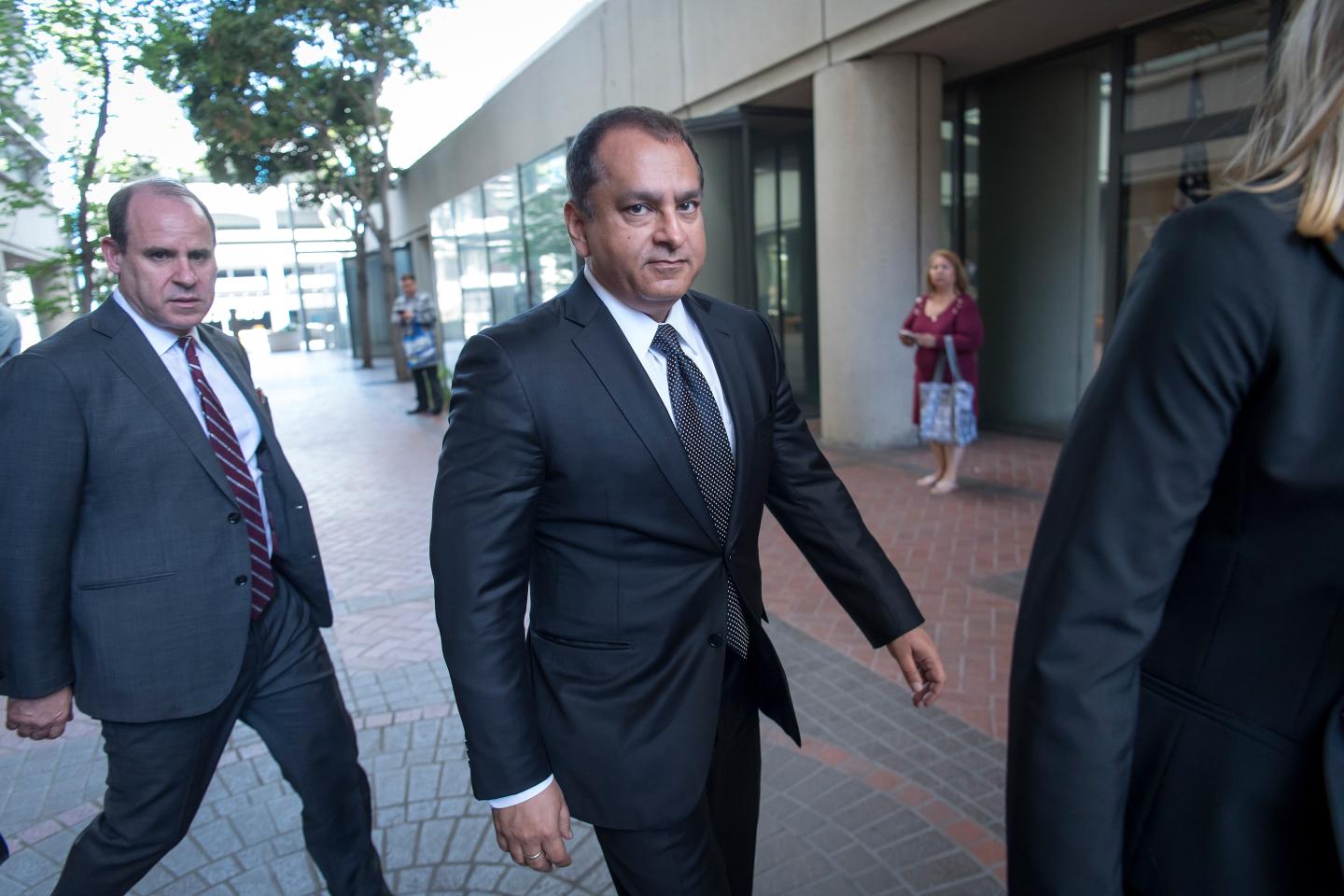 Ramesh "Sunny" Balwani walks outside.