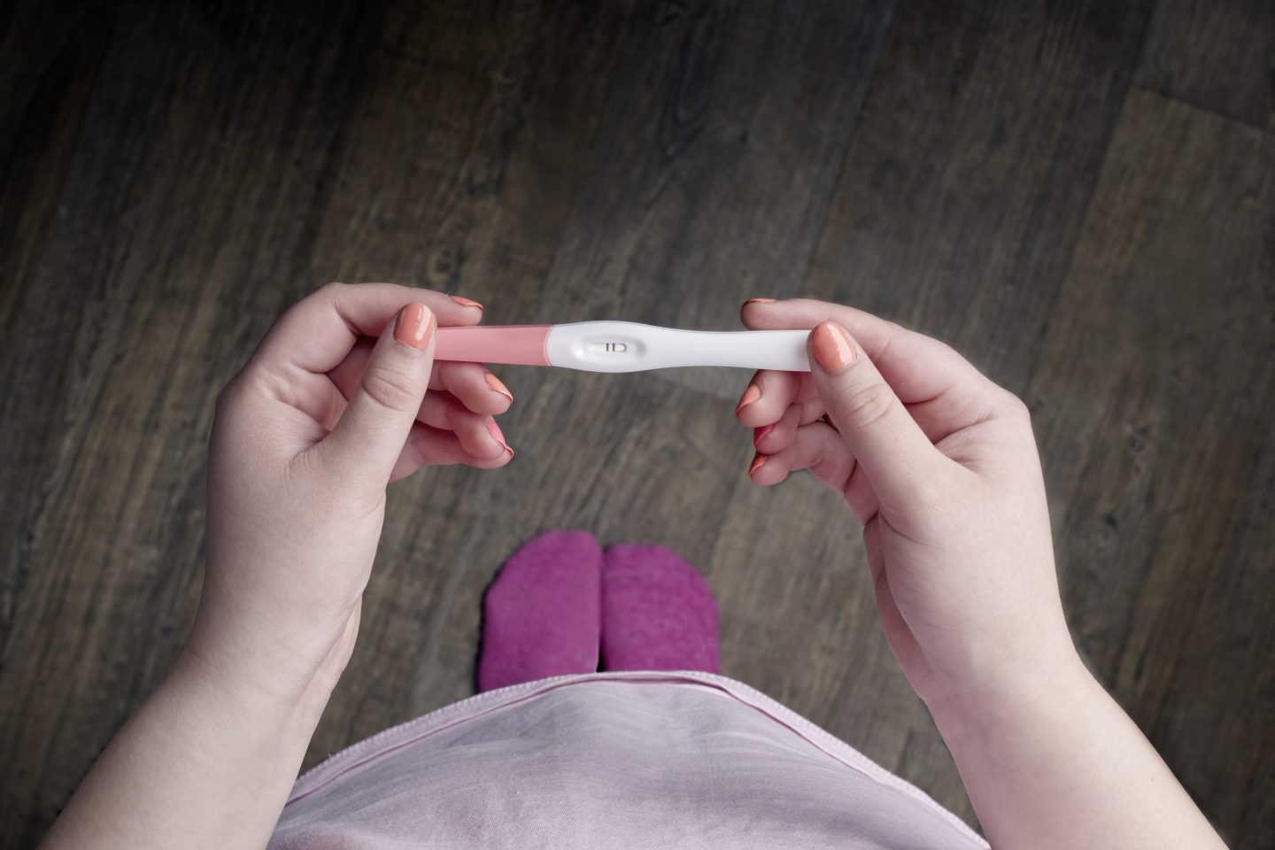 A woman holding a pregnancy tests