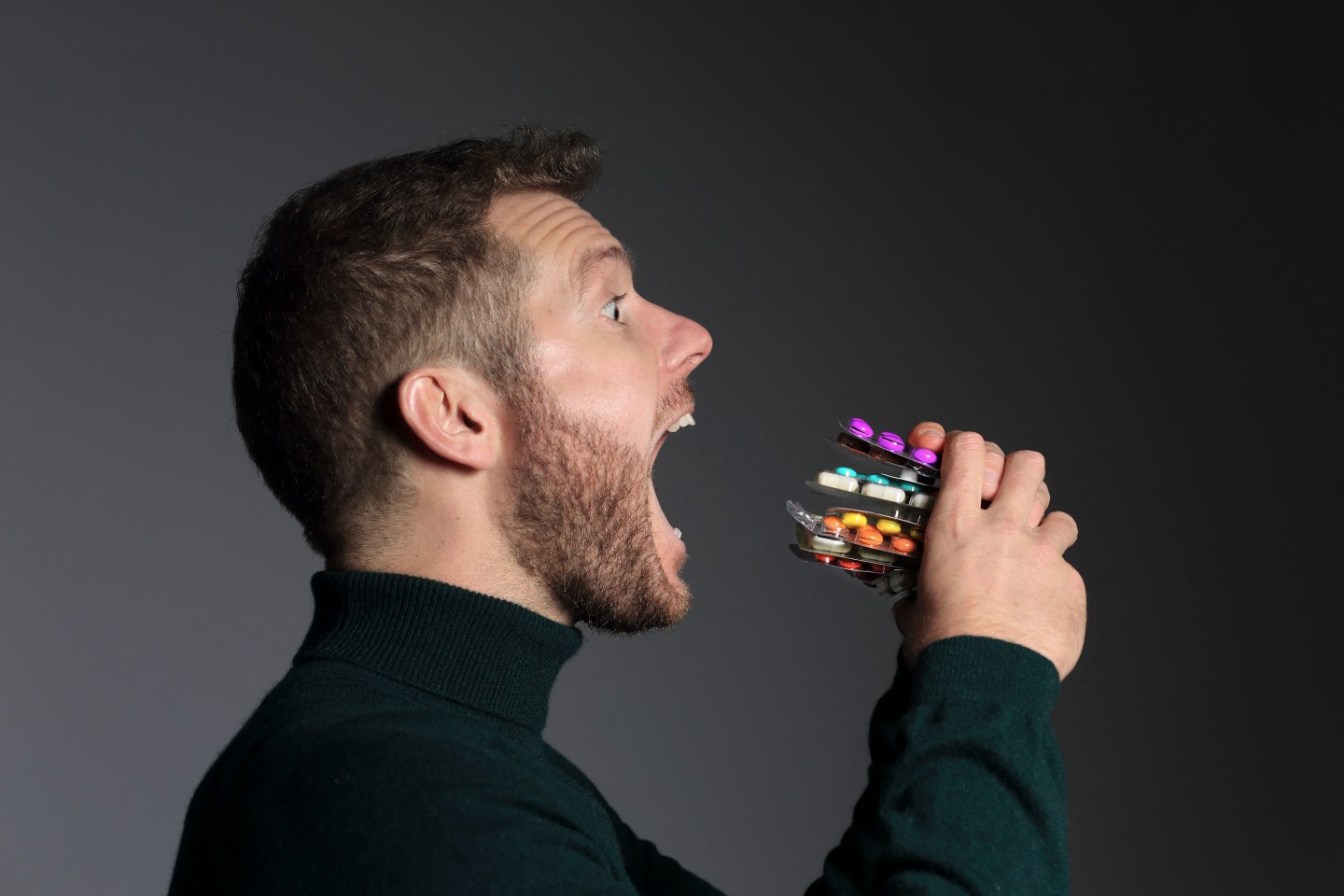 A man holding pills.