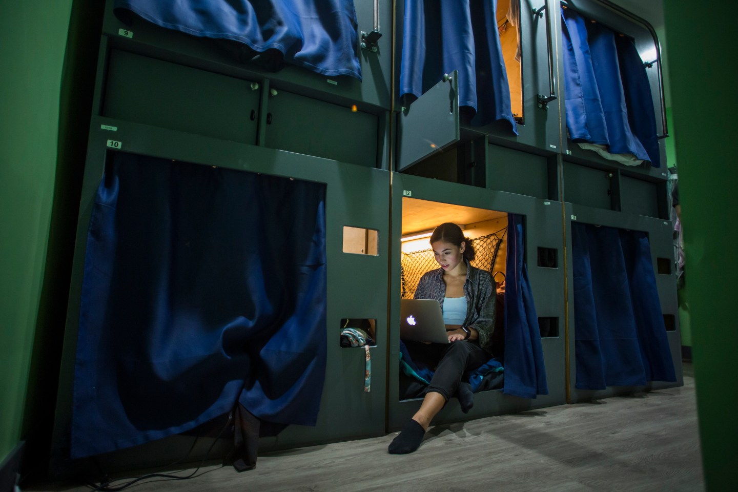 Kay Wilson poses in her pod in the UP (st)ART house in Los Angeles, California, on October 24, 2019. Wilson packed up her life in a hurry and moved to Los Angeles ... only to find that what she paid in Pennsylvania for a nice studio apartment would only get her a 2.9-square-meter box in California. Her new home is a capsule, inspired by the famous hotels in Japan. Wilson arrived a month ago at UP(st)ART, a community for young people with artistic aspirations in need of an affordable place to live. Each room contains up to six capsules, which Wilson describes as "cozy." They contain a single bed, a bar for hanging clothes, a few compartments for storing shoes and other items, and an air vent.