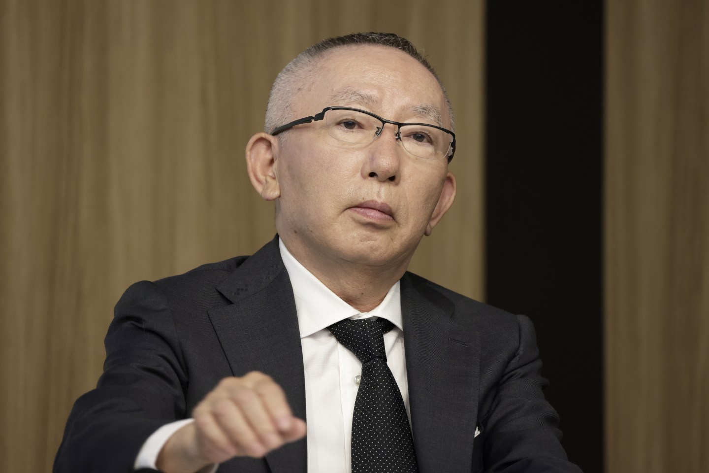 Tadashi Yanai, chairman and chief executive officer of Fast Retailing Co., attends a news conference.