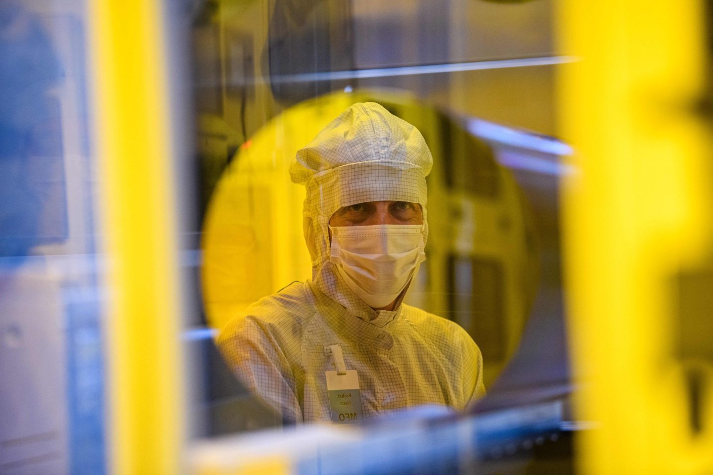 An employee of the semiconductor manufacturer Bosch works in a clean room.